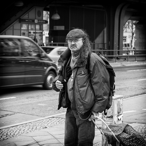 Homeless pedestrian with drink