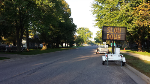 Digital speed sign reading "slow down"