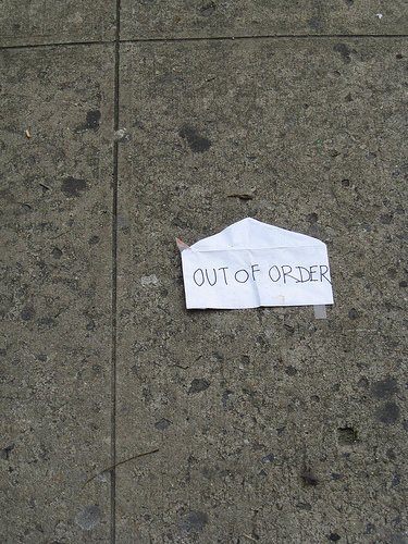 Out of order sign on sidewalk