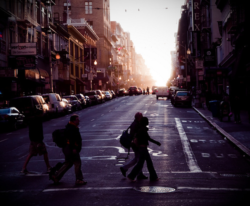 Pedestrians with hazy sunrise