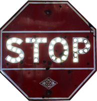 Red Stop sign with glowing cat’s eyes